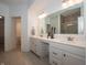 Bright bathroom showcasing double vanity with white cabinets, quartz counters, and neutral tile floor at 182 Batteese Dr, Cicero, IN 46034
