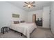 Bright bedroom features soft carpet, ceiling fan, and comfortable queen bed with attractive decor at 182 Batteese Dr, Cicero, IN 46034