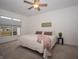 Cozy bedroom with a queen-size bed, soft lighting, and a view of the neighborhood at 182 Batteese Dr, Cicero, IN 46034