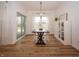 Dining area featuring a wooden table, white chairs, cabinet, and natural light from sliding glass doors at 182 Batteese Dr, Cicero, IN 46034