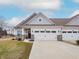 Charming townhome showcases a two-car garage, stone accents and well-maintained lawn at 182 Batteese Dr, Cicero, IN 46034