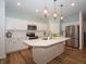 Modern kitchen featuring white cabinets, stainless steel appliances, and a large center island at 182 Batteese Dr, Cicero, IN 46034