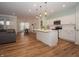 Open-concept kitchen with white cabinetry, stainless appliances, and a large island with pendant lighting at 182 Batteese Dr, Cicero, IN 46034