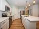 A well-equipped kitchen with stainless steel appliances, white cabinets, and a large kitchen island at 182 Batteese Dr, Cicero, IN 46034