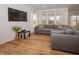 Comfortable living room with a large sectional sofa, multiple windows, and light wood flooring at 182 Batteese Dr, Cicero, IN 46034
