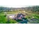 Aerial view of a community center with a pool, playground, and pond nestled in a scenic setting at 1950 Midnight Pass, Brownsburg, IN 46112