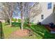 Landscaped backyard featuring mature trees, grass and mulch at 1950 Midnight Pass, Brownsburg, IN 46112