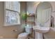 Well-lit powder room featuring a pedestal sink and decorative accents at 1950 Midnight Pass, Brownsburg, IN 46112