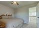 Bright bedroom features carpet flooring, a ceiling fan, and an open door at 1950 Midnight Pass, Brownsburg, IN 46112