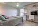 Well lit bedroom with built-in shelving, desk and carpet flooring at 1950 Midnight Pass, Brownsburg, IN 46112