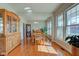 Sunlit dining room featuring gleaming hardwood floors and large windows with outdoor views at 1950 Midnight Pass, Brownsburg, IN 46112