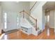 Spacious foyer featuring hardwood floors, a staircase, and a bench for storage at 1950 Midnight Pass, Brownsburg, IN 46112
