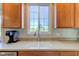 Bright kitchen sink with stainless steel appliances, granite countertops, and a large window view at 1950 Midnight Pass, Brownsburg, IN 46112