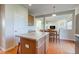 Open concept kitchen with central island, wood floors, seamlessly connects to the dining and living areas at 1950 Midnight Pass, Brownsburg, IN 46112