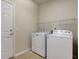 Clean laundry room with standard washer and dryer and overhead shelving at 1950 Midnight Pass, Brownsburg, IN 46112