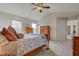 Spacious bedroom with carpet flooring, a ceiling fan, and two windows for natural light at 1950 Midnight Pass, Brownsburg, IN 46112