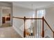 Carpeted staircase with white spindles and stained wood banister, chandelier overhead at 1950 Midnight Pass, Brownsburg, IN 46112