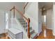 Carpeted staircase with white spindles and stained wood banister at 1950 Midnight Pass, Brownsburg, IN 46112