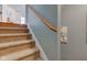Carpeted stairway with wood handrail leads to the upper level of the home at 1950 Midnight Pass, Brownsburg, IN 46112