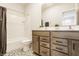 Well-lit bathroom with a modern vanity, decorative tile flooring, and a combination tub and shower at 2023 Alvord St, Indianapolis, IN 46202