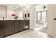 Modern bathroom showcasing a double sink vanity, large mirror, and an open doorway leading into the main bedroom at 2023 Alvord St, Indianapolis, IN 46202