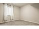 Cozy bedroom featuring neutral carpet, a window with white curtains, and ample natural light for a serene atmosphere at 2023 Alvord St, Indianapolis, IN 46202