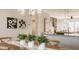 Open-concept dining area adjacent to the kitchen, featuring stylish artwork and a rustic table at 2023 Alvord St, Indianapolis, IN 46202