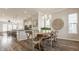 Elegant dining area featuring hardwood floors, a rustic table, and ample natural light at 2023 Alvord St, Indianapolis, IN 46202
