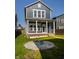 Stunning home exterior with a classic blue facade, inviting front porch, and beautifully landscaped front yard at 2023 Alvord St, Indianapolis, IN 46202
