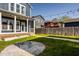 Charming home exterior featuring a cozy front porch, well-maintained lawn, a modern firepit area, and stylish neighborhood views at 2023 Alvord St, Indianapolis, IN 46202