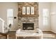 Elegant stone fireplace with a wooden mantle and decorative artwork above at 2023 Alvord St, Indianapolis, IN 46202