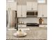 Close-up of a kitchen with white cabinets, stainless appliances, and granite countertops at 2023 Alvord St, Indianapolis, IN 46202