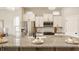 Bright kitchen featuring white cabinets, granite countertops, and stainless steel appliances at 2023 Alvord St, Indianapolis, IN 46202