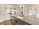 Bright kitchen with granite countertops, stainless steel appliances, and wood-style flooring at 2023 Alvord St, Indianapolis, IN 46202