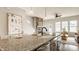 Modern kitchen island featuring granite countertops, a sink, and stainless steel appliances at 2023 Alvord St, Indianapolis, IN 46202