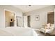 Bright main bedroom featuring neutral tones, a comfortable armchair, and ensuite bathroom and walk-in closet entrances at 2023 Alvord St, Indianapolis, IN 46202