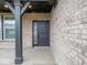Close up on a modern front door with brick surround and black accents at 20398 N Pacific Ave, Westfield, IN 46074