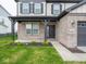 Inviting front entrance with a covered porch, brick accents, and manicured landscaping at 20398 N Pacific Ave, Westfield, IN 46074