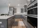 Modern kitchen with stainless appliances, gray cabinets, and a white center island at 20398 N Pacific Ave, Westfield, IN 46074