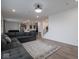 Open concept living area showcasing a gray sectional couch and wood floors at 20398 N Pacific Ave, Westfield, IN 46074
