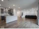 Open concept living area showcasing kitchen, staircase, and gray sectional couch at 20398 N Pacific Ave, Westfield, IN 46074