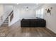 Bright living room featuring a staircase and a large sofa at 20398 N Pacific Ave, Westfield, IN 46074