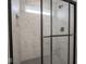 Contemporary shower with white marble tiles, hexagon floor, and a sleek glass door at 20398 N Pacific Ave, Westfield, IN 46074