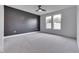 Spacious bedroom featuring a black accent wall, plush carpet, and large windows for natural light at 2144 Connie Ct, Franklin, IN 46131