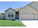 Charming single-story brick home with a well-manicured lawn and a two-car garage at 2144 Connie Ct, Franklin, IN 46131