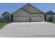 A modern duplex with a wide concrete driveway leading to two garages at 2144 Connie Ct, Franklin, IN 46131