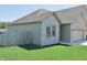 A side view of a well-maintained single-story home with a fenced yard and manicured lawn at 2144 Connie Ct, Franklin, IN 46131