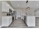 Kitchen features stainless steel appliances, white cabinets, quartz countertops, and an island with sink at 2144 Connie Ct, Franklin, IN 46131