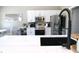 Modern kitchen with stainless steel appliances, white cabinetry, and island with black spring faucet at 2144 Connie Ct, Franklin, IN 46131