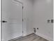 White laundry room with a modern door and electrical outlets for appliances at 2144 Connie Ct, Franklin, IN 46131